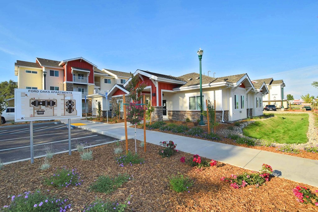 a group of townhomes with a street sign in front of them