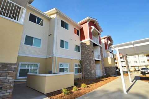 a street view of an apartment building with a sidewalk