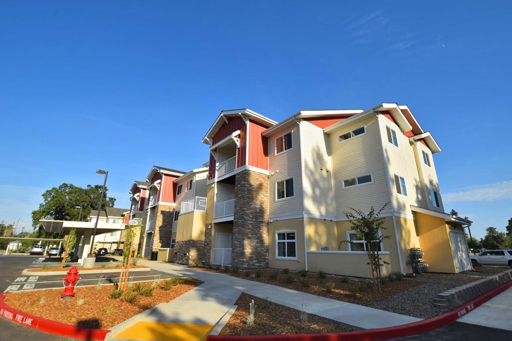 a row of apartments with a fire hydrant in front of them