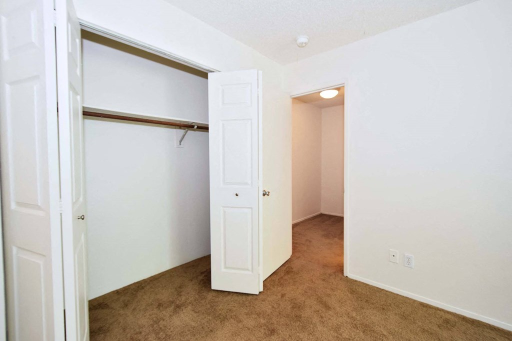 a bedroom with a closet and an open door
