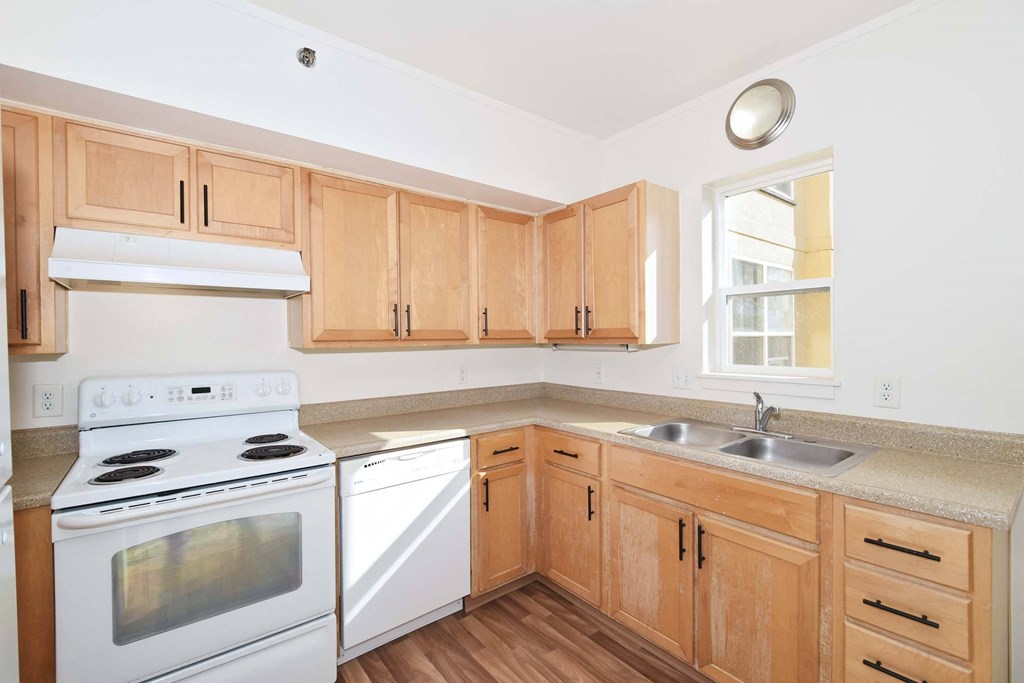 a kitchen with wooden cabinets and white appliances
