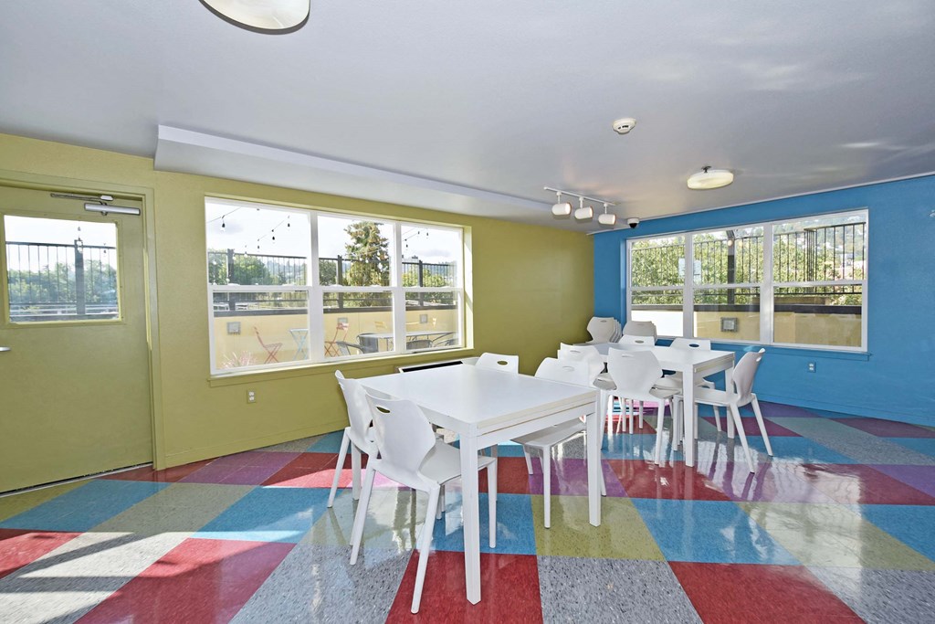 a dining room with tables and chairs and windows