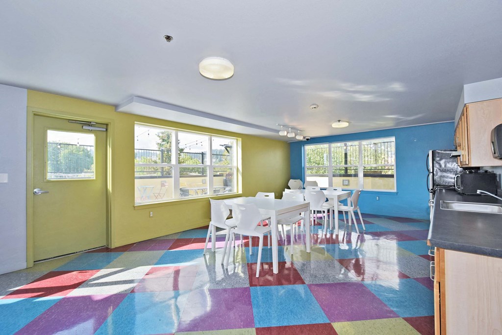 a dining room with a table and chairs and a kitchen