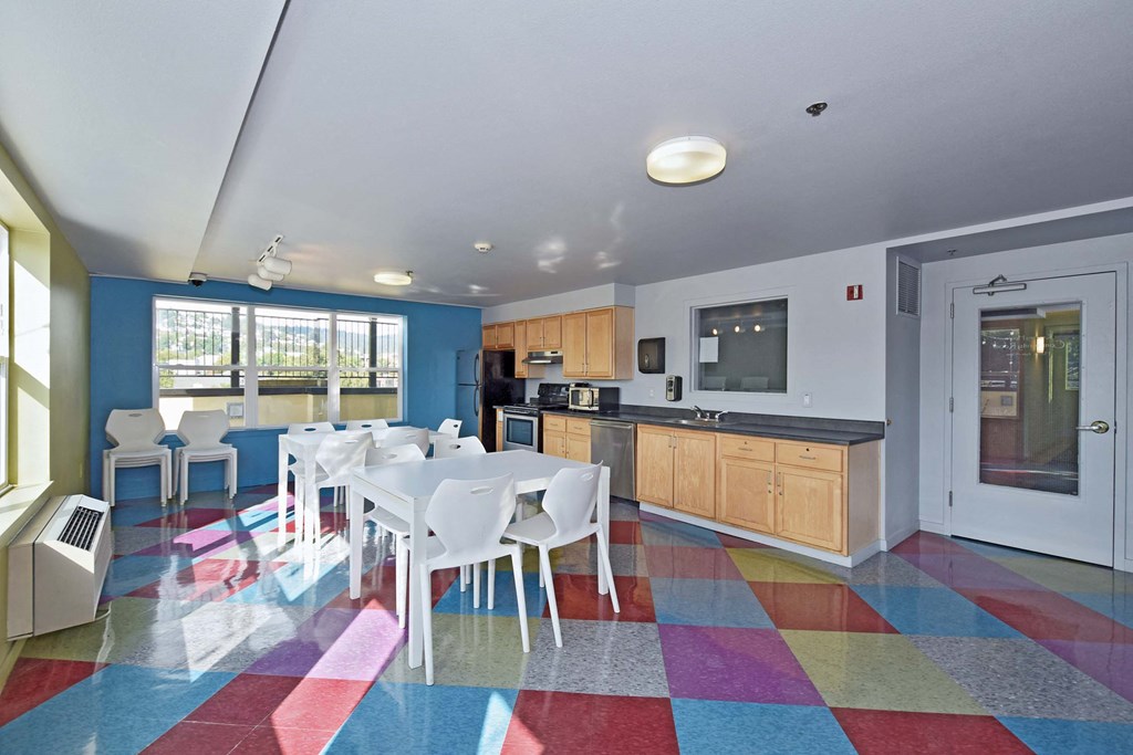 a kitchen and dining room with a table and chairs