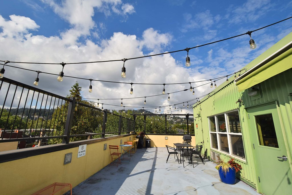 a patio with patio furniture and lights on a roof