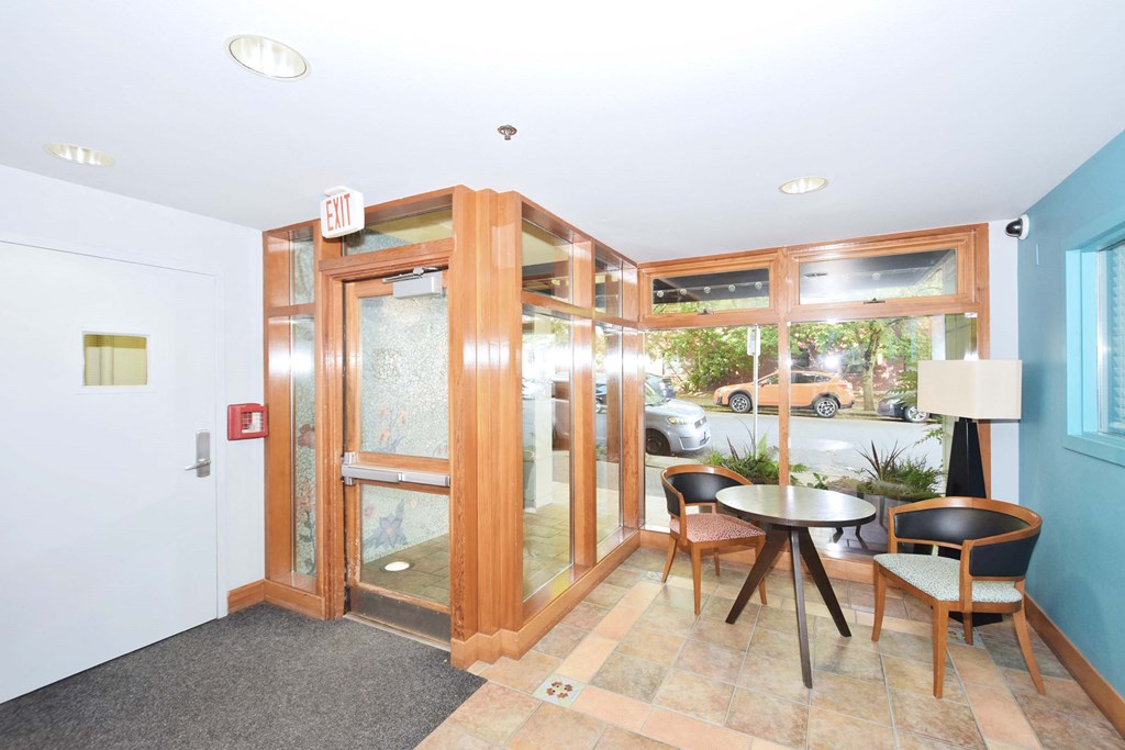 a dining room with a table and chairs in front of a glass door