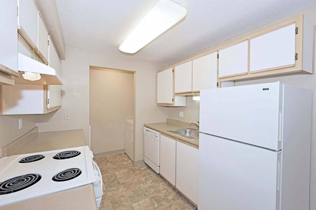 a kitchen with white appliances and white cabinets