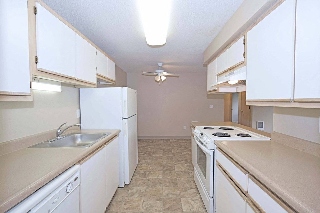 a kitchen with white appliances and white cabinets