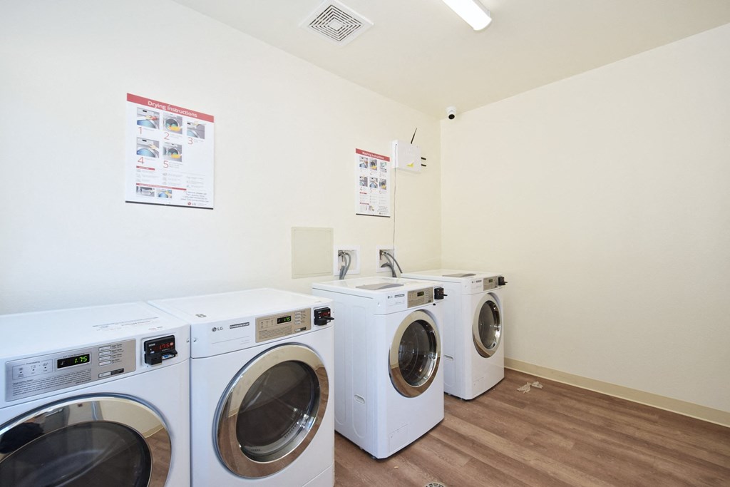 a laundry room with washing machines and a sink