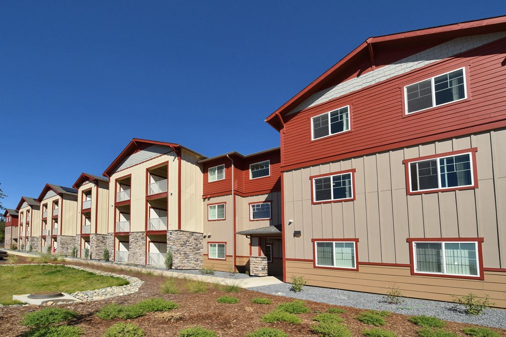 a row of new apartment buildings on a sunny day