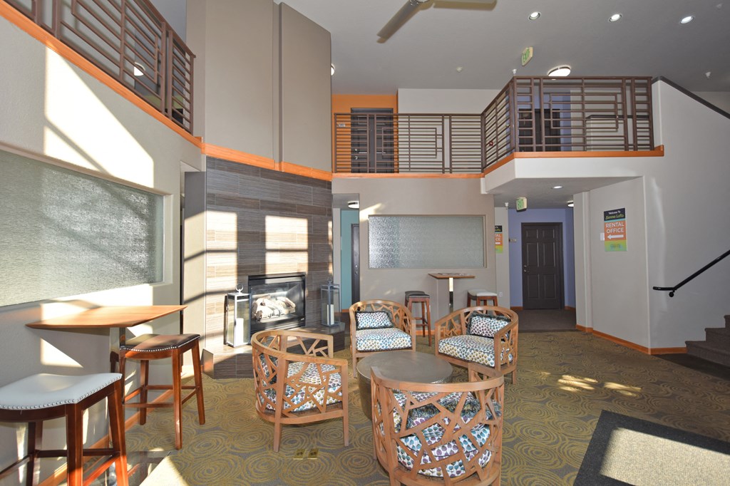 a living room with tables and chairs and a fireplace