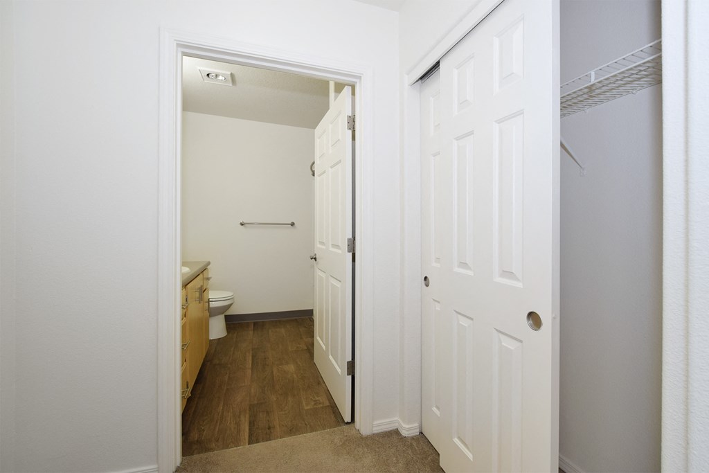 a small bathroom with a white door and a toilet