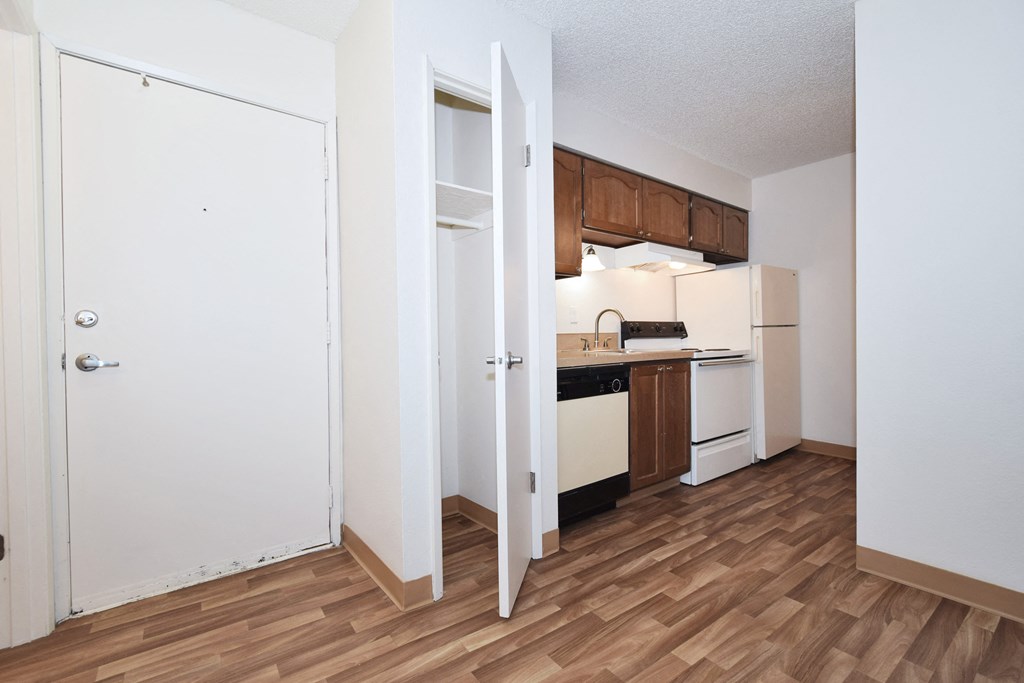 a renovated kitchen with wood flooring and white appliances