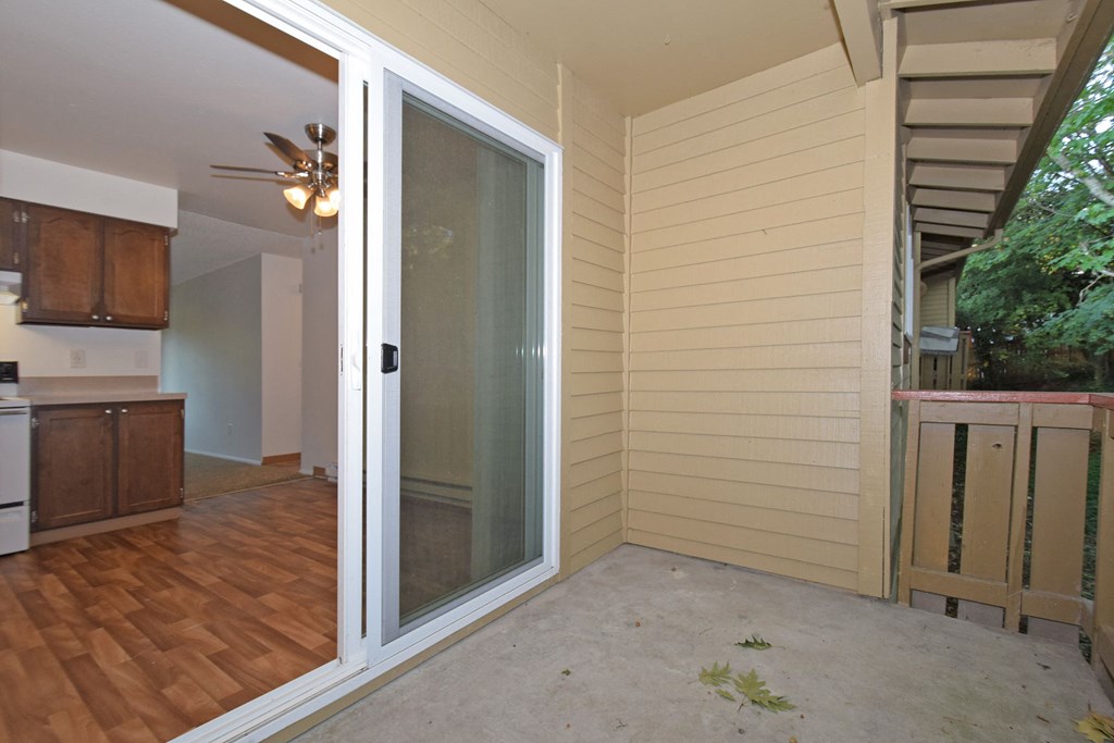 a sliding glass door leading into a kitchen and living room