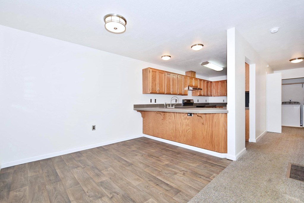 Twin Oaks Apartments iving room and kitchen with wood flooring