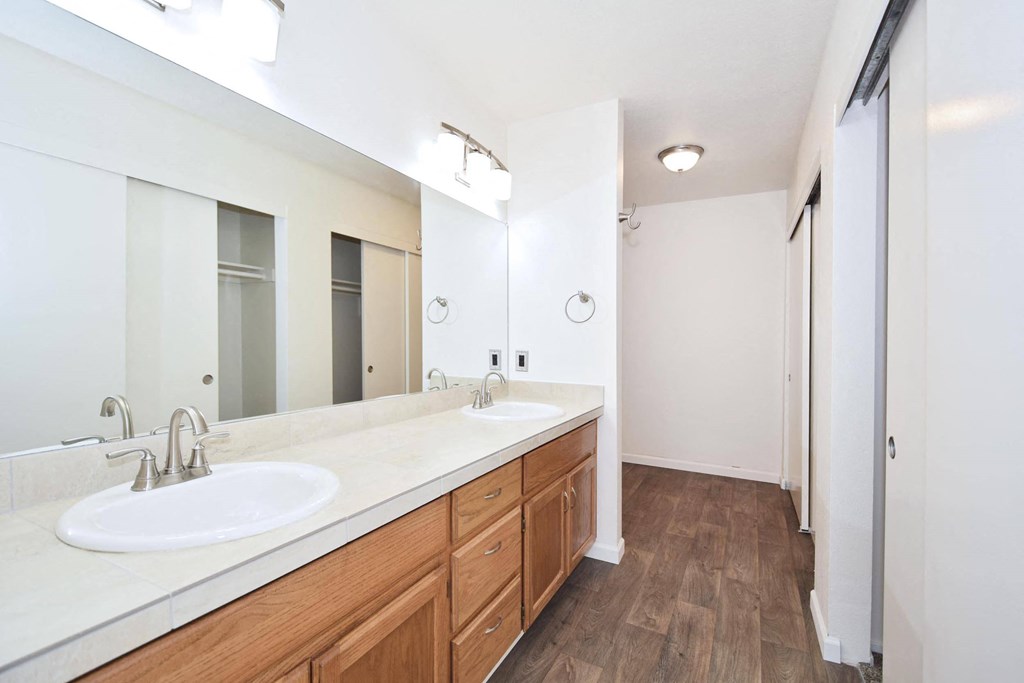 Twin Oaks Apartments a bathroom with two sinks and a large mirror