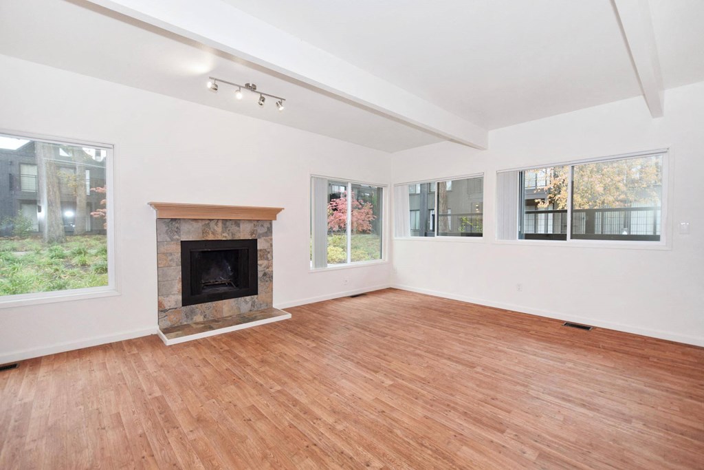 a living room with a fireplace and a wooden floor
