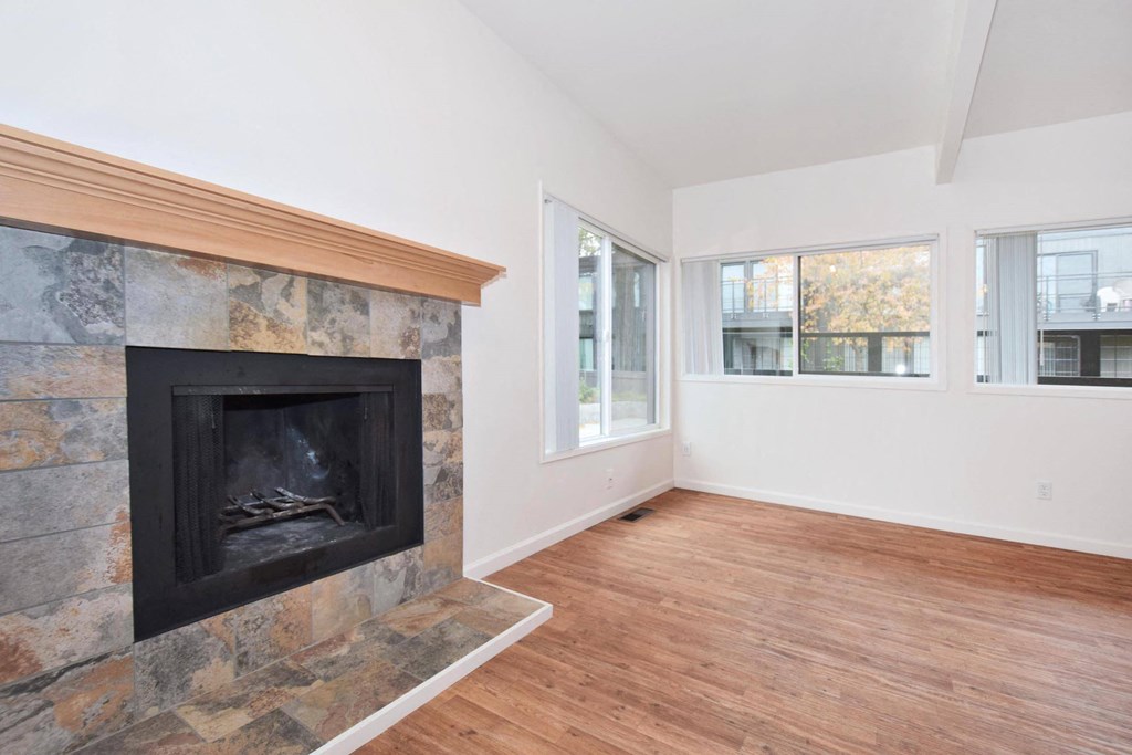 a living room with a fireplace and a wooden floor
