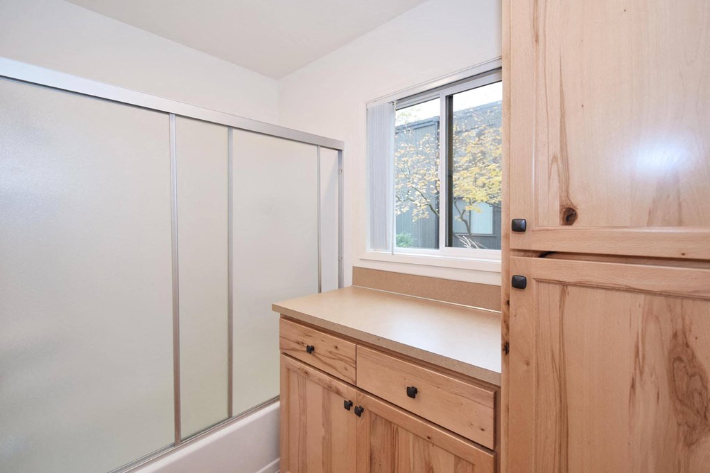 a small bathroom with a sink and a window