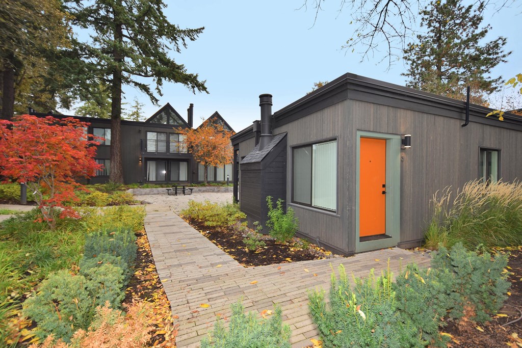 the exterior of a house with an orange door