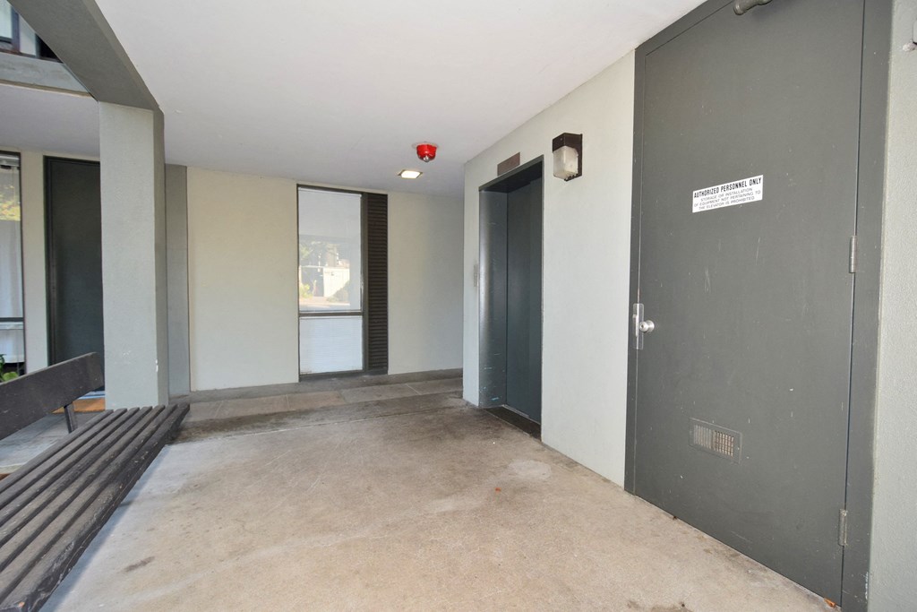 an empty room in a building with a door to a bathroom