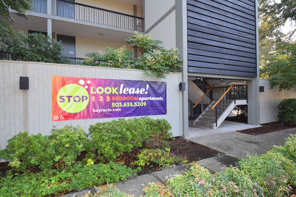 a sign on the side of a building that reads stop and look lease