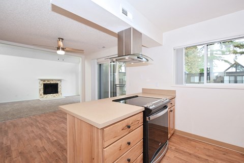 a kitchen with an island and a stove and a large window