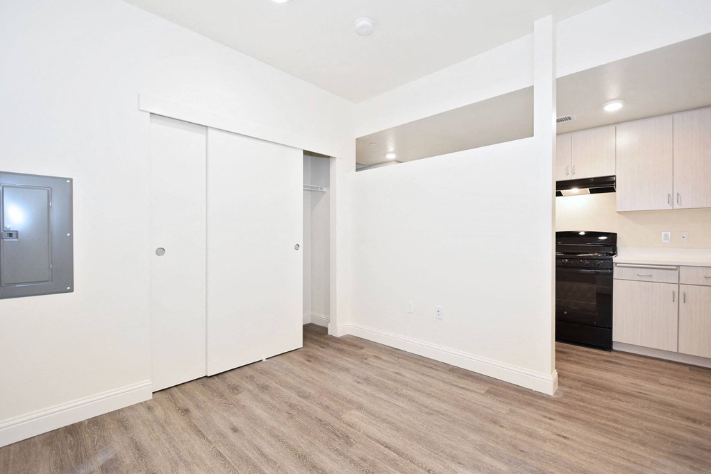 a renovated living room with white walls and wood flooring