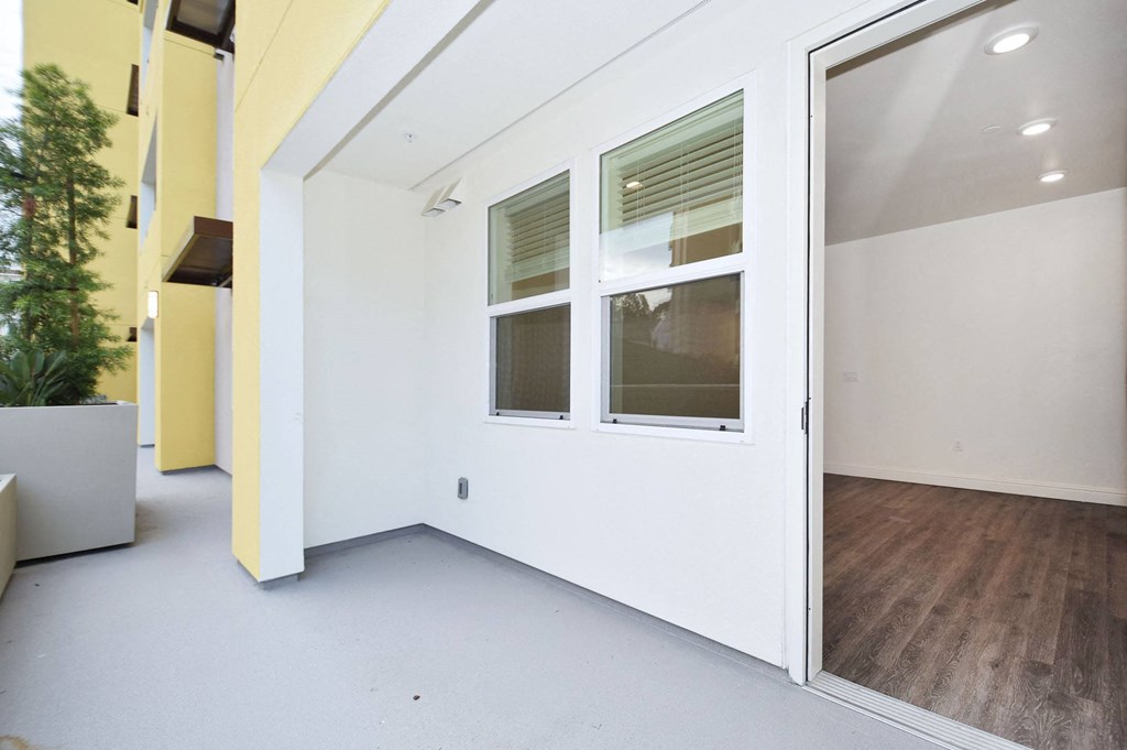 an empty room with white walls and a glass door