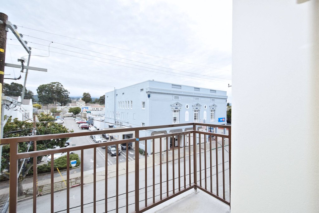 a balcony with a view of a street and a building