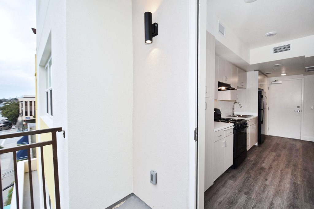 a view of a kitchen and a living room from a balcony