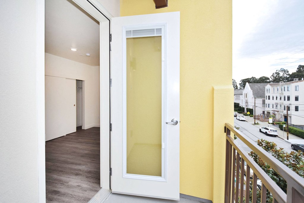 a view of a balcony with a door that is open