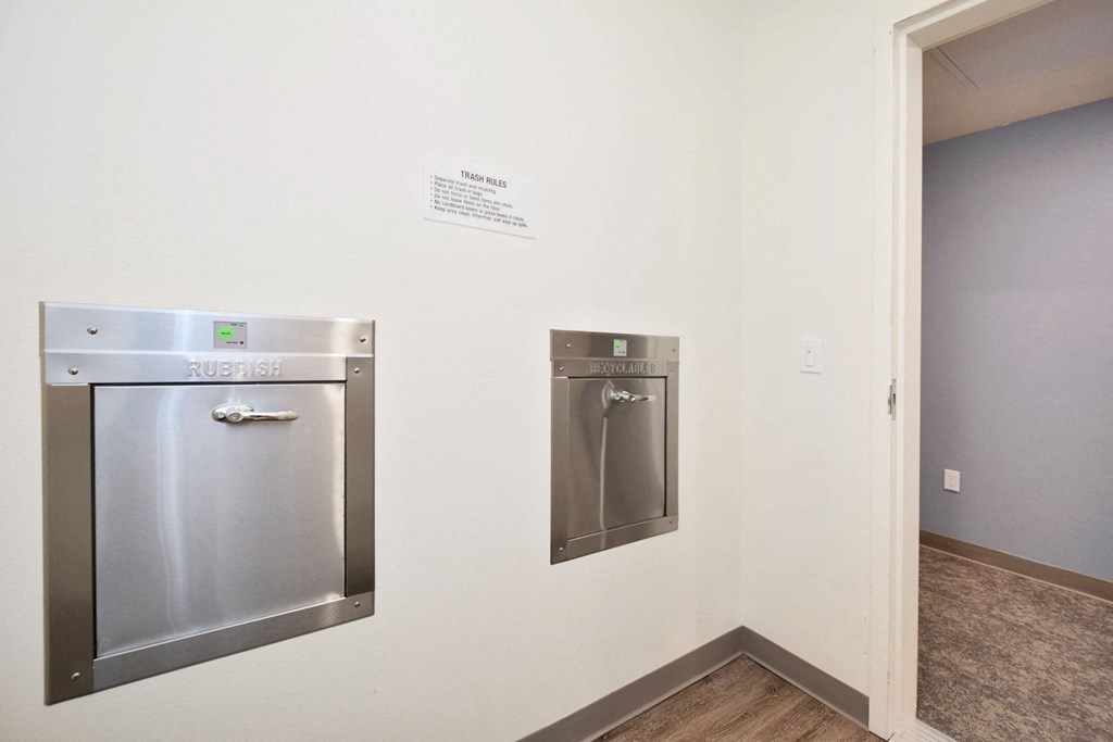 a kitchen with stainless steel appliances and a sign on the wall