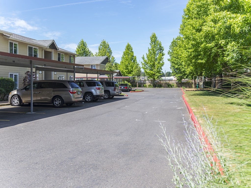 a parking lot with cars parked in front of a building