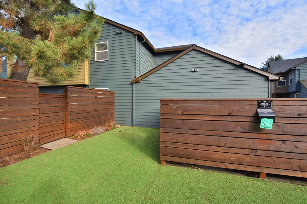 a wooden fence in front of a house