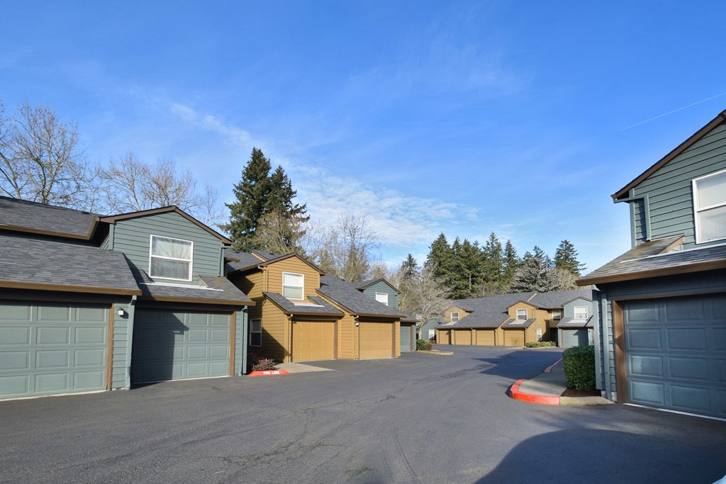 a row of houses with a street in front of them
