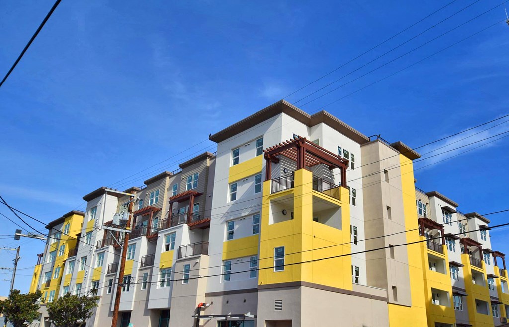 a colorful apartment building with power lines in front of it