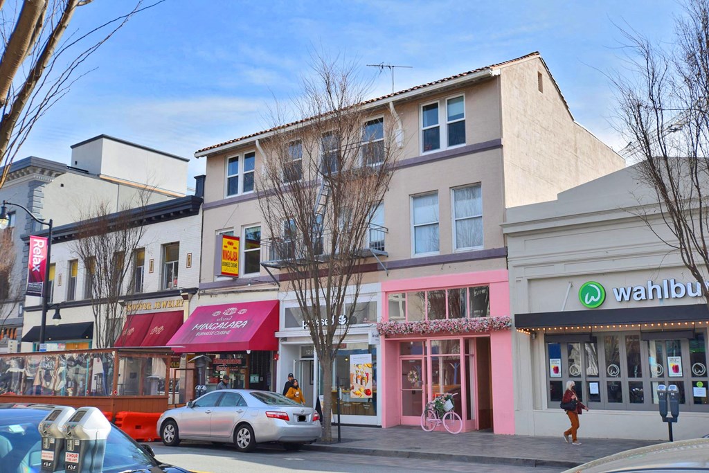 a city street with stores and cars on it
