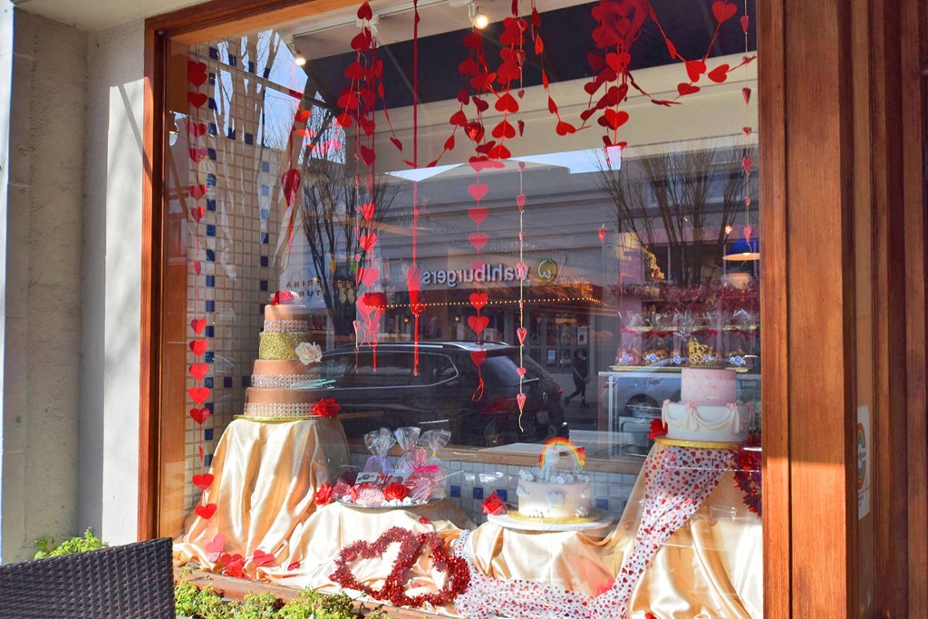 a window display of cakes and other items in a store