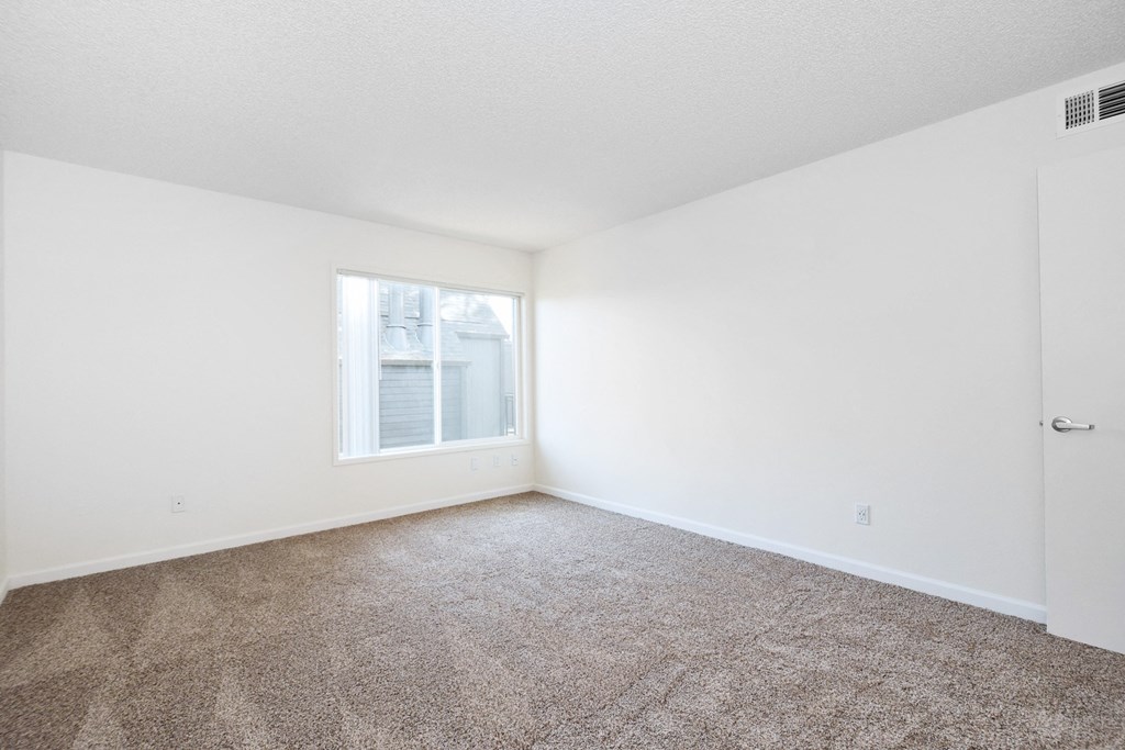 Timberwood Beaverton:  a bedroom with white walls and carpet