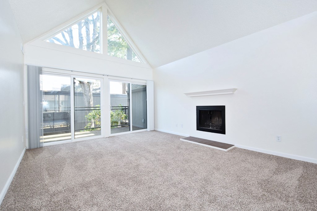 Timberwood Beaverton:  a living room with a vaulted ceiling and a fireplace