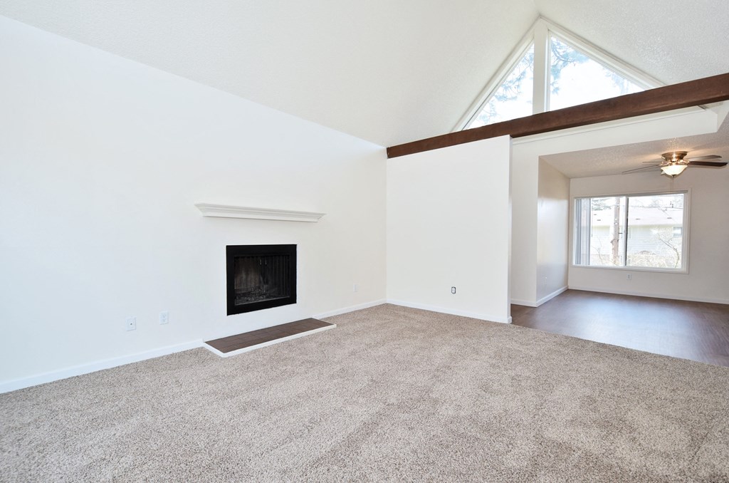 Timberwood Beaverton:  a living room with a fireplace and a ceiling fan