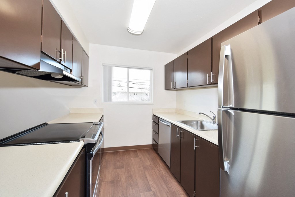 Timberwood Beaverton:  a kitchen with dark cabinets and white countertops