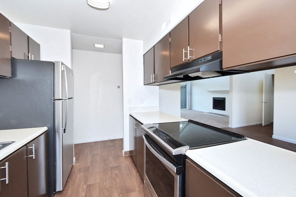 Timberwood Beaverton:  a kitchen with brown cabinets and white countertops
