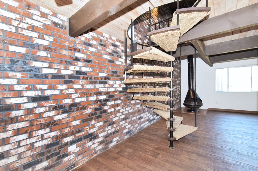 a spiral staircase leads to the second floor