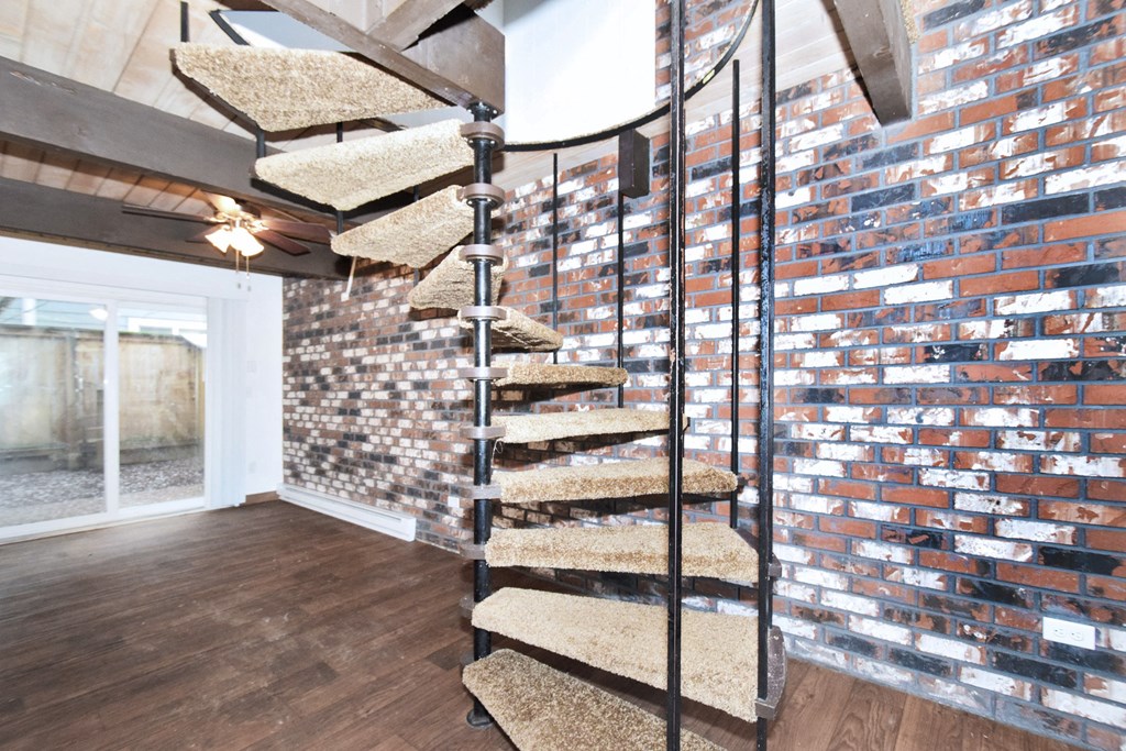 a spiral staircase leads to the loft