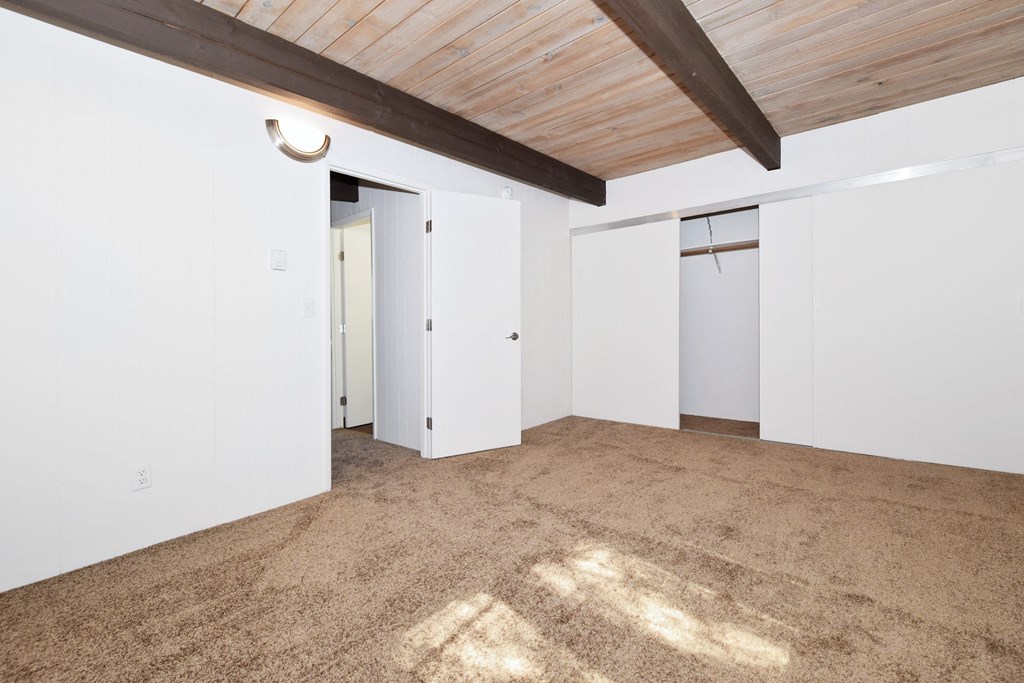 a bedroom with a carpeted floor and white walls