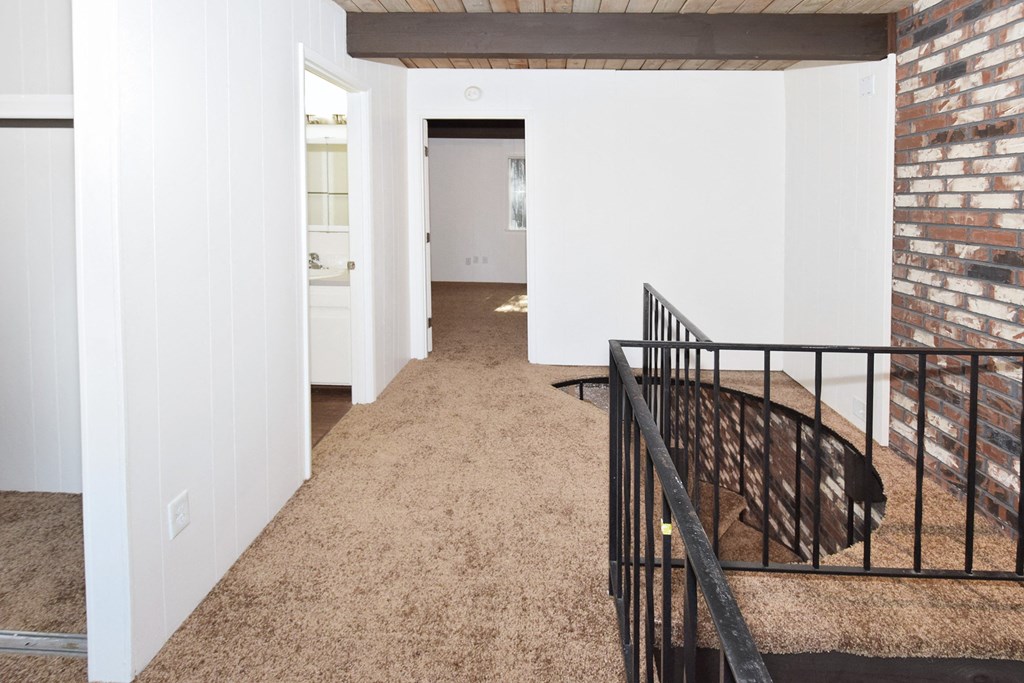 a view of the hallway from the top of the stairs