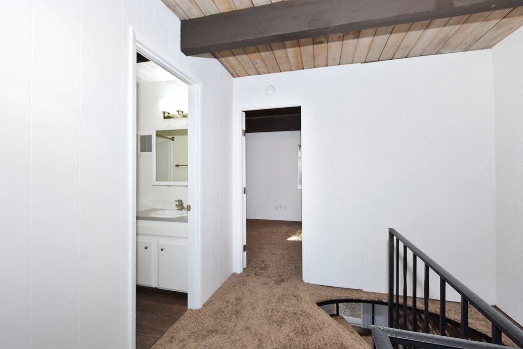 a view of the hallway from the top of the stairs