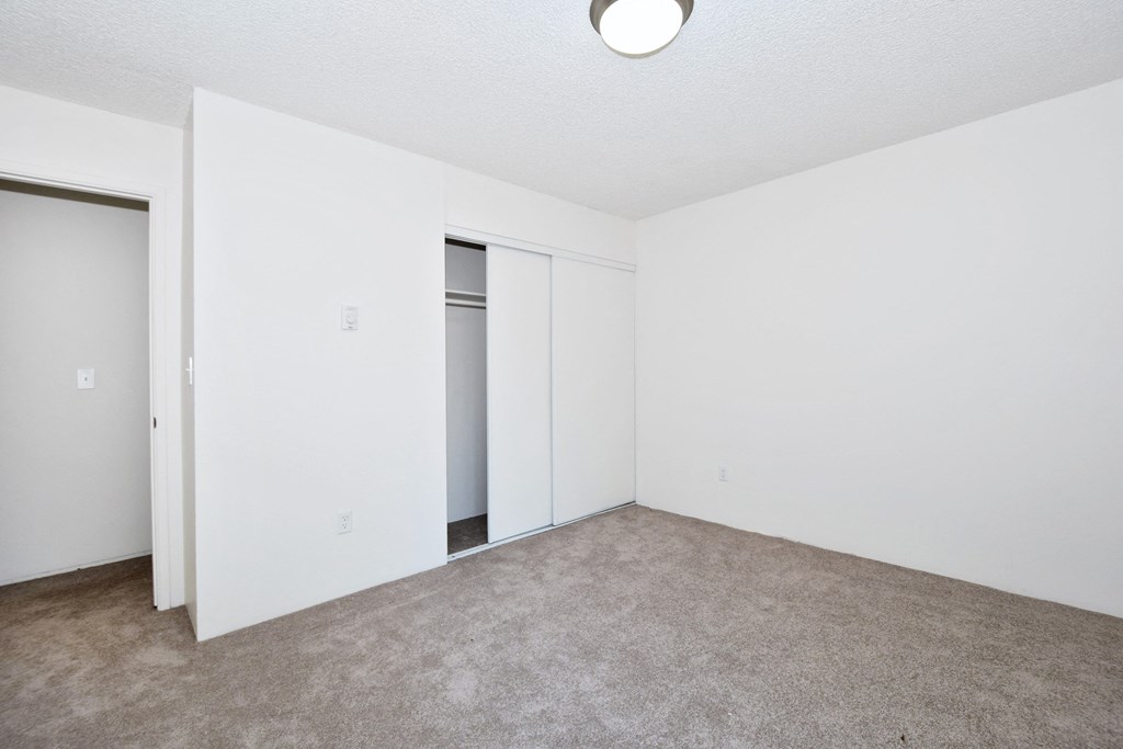 Menlo Manor:  bedroom with a carpeted floor and white walls